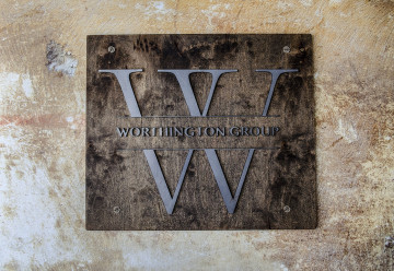 Raw steel letters and logo mounted to a wood background