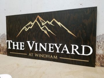 Exterior wood stained with digital print and raised acrylic letters